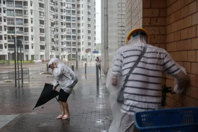 People brave strong winds as Super Typhoon Ragasa approaches, in Hong Kong, China, September 24, 2025