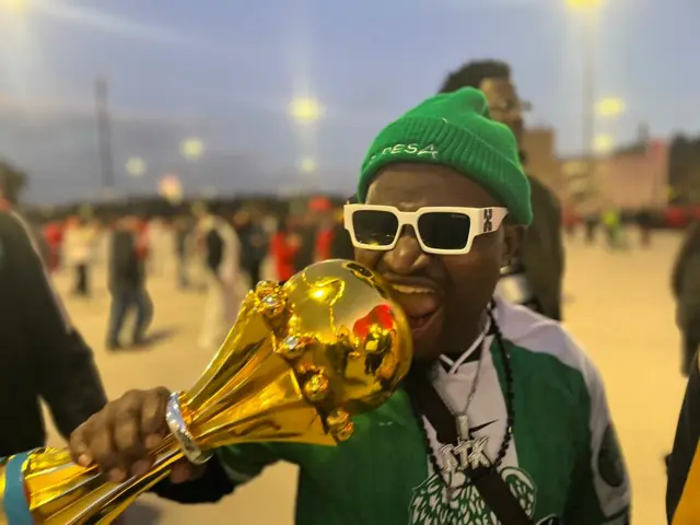 E wear Nigeria national green and white jersey wit green winter cap and white sunglasses