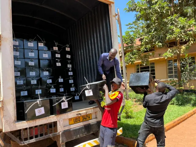 Mahamali wakisaidia kubeba makasha ya karatasi za kupigia kura