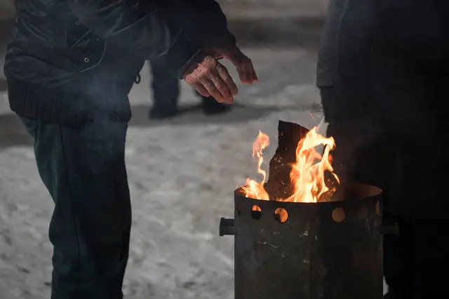 Люди греются в Киеве у костра