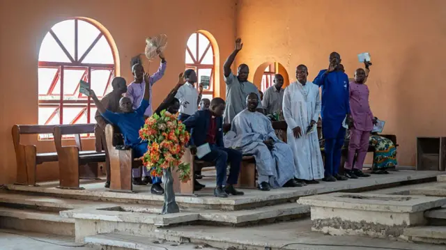 Worshippers pray at the Evangelical Church Winning All (ECWA) during a prayer called by the Christian Association of Nigeria (CAN) in Minna on December 7, 2025.