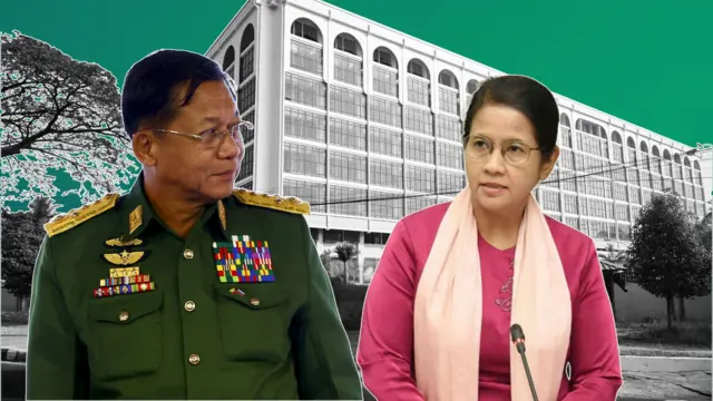 ရန်ကုန်မြို့က ဗဟိုဘဏ် အဆောက်အဦနောက်ခံနဲ့ အတူမြင်ရတဲ့ မြန်မာစစ်ခေါင်းဆောင် ဗိုလ်ချုပ်မှူးကြီး မင်းအောင်လှိုင်နဲ့ ဗဟိုဘဏ်ဥက္ကဋ္ဌ ဒေါ်သန်းသန်းဆွေတို့ကို မြင်တွေ့ရတာဖြစ်ပါတယ်။