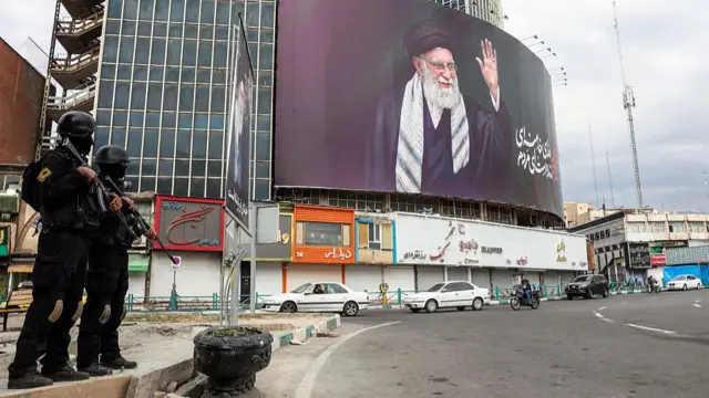 بنر تبلیغاتی میدان انقلاب و دو نیروی نظامی در خروجی میدان دیده میشوند