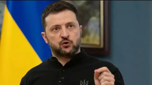 Zelensky arimo kuvuga, akoze ikimenyetso n'ikiganza.