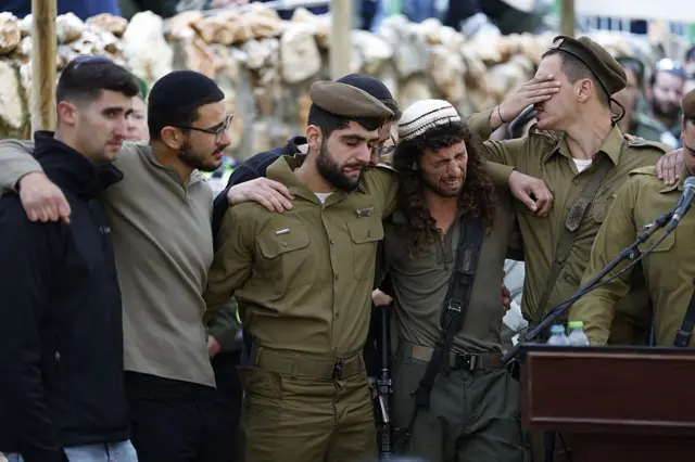 جنود إسرائيليون يودعون جثمان الرقيب أول أوري غرينبيرغ، 21 عاماً ، في مقبرة جبل هرتزل العسكرية بالقدس في 26 مارس/أذار 2026، ويظهر في الصورة أربعة عسكريين إسرائيليين يرتدون زياً عسكرياً وشخصان آخران يرتديان زياً مدنياً