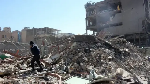 A view of damaged buildings around Ferdowsi Square after an airstrike in central Tehran, Iran on 3 March