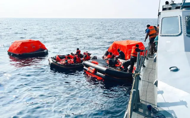 Sri Lanka Navy personnel assist Iranian sailors during a rescue operation after a distressed Iranian vessel was intercepted in waters off Galle in southern Sri Lanka. The sailors were transferred from life rafts to naval craft as part of a humanitarian rescue operation.