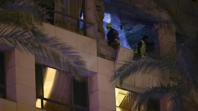 Equipes de resgate inspecionam os danos em um hotel em Beirute após ataque israelense ao prédio, que matou pelo menos quatro pessoas