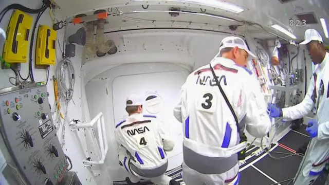 Personal de la NASA operando la cápsula