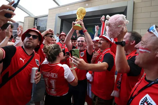 Austria fans lifting a World Cup replica