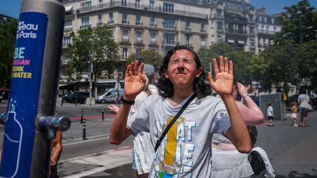 Ifoto igaragaza umukobwa uri kwikonjesha ku mazi azamuka i Paris