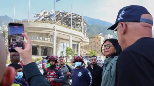 Delcy y Jorge Rodríguez junto a un grupo de rescatistas delante de un edificio colapsado.