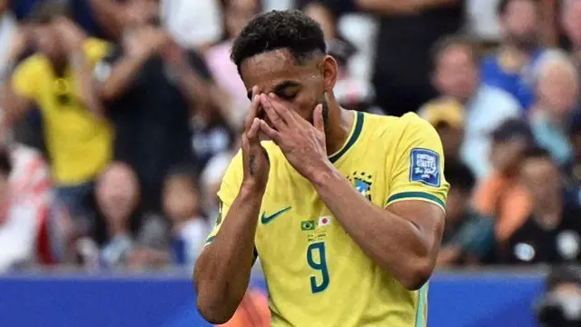 Brazil's forward #09 Matheus Cunha reacts after missing a goal opportunity during the 2026 World Cup round of 32 football match between Brazil and Japan.