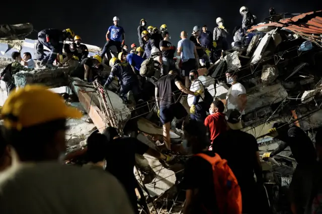 Equipos de rescate trabajan de noche en el lugar de un edificio colapsado tras un terremoto en Cali.