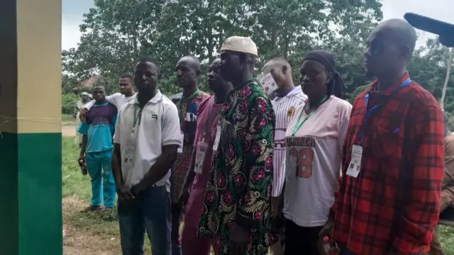 Party agents including one woman stand for group foto