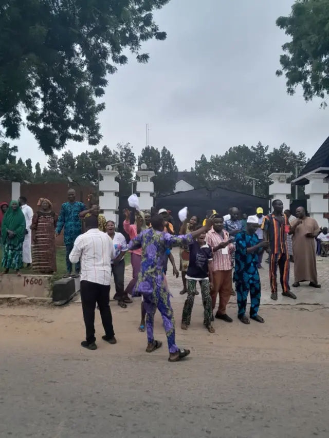 Men and women, young and old stand for one gate in happy mood