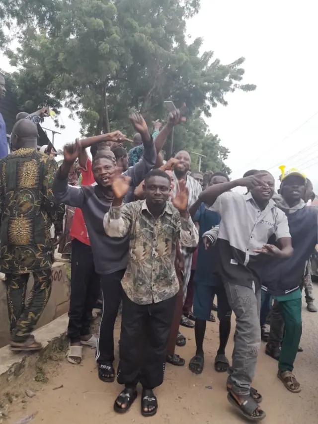 Group of young men wey dey happy face camera as dem pose for foto