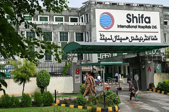 Police personnel walk past Shifa International Hospital following Pakistan's former prime minister Imran Khan's medical examination in Islamabad on August 21, 2026.