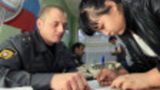 Приезжая из Центральной Азии заполняет документы в полицейском участке в Красноярске 19 сентября 2013 г.
