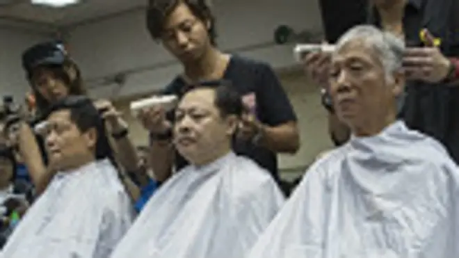 「佔領中環」運動發起人陳健民（左）、戴耀廷（中）和朱耀明（右）在記者面前讓髮型師削髮（9/9/2014）