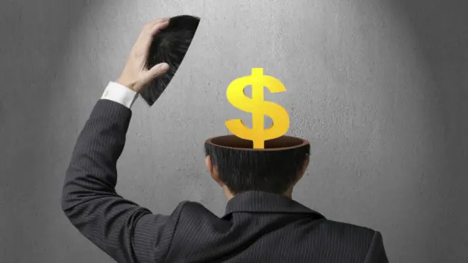 Ilustración de una cabeza abierta con un símbolo de dólar adentro