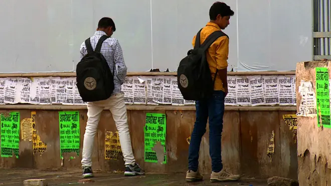 दीवार पर पेशाब करते पुरुष