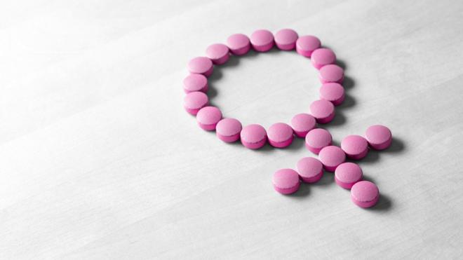Pílulas rosas formam o símbolo do feminino