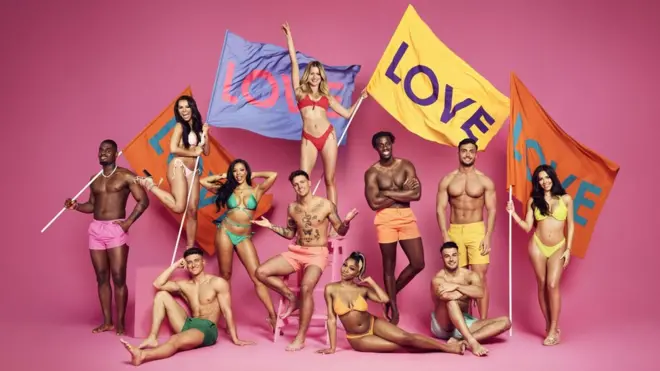 The 2022 Love Island contestants holding flags that read Love. The new series started on ITV on 6 June