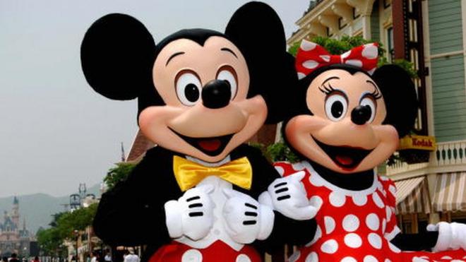 Mickey and Minnie Mouse walk around the Main Street of Hong Kong Disneyland during a preview of the park