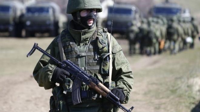 Armed man, believed to be Russian soldier, in Crimea