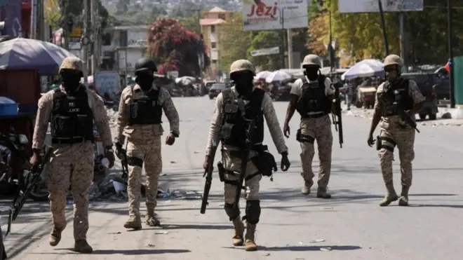 Police patrol a street in Port-au-Prince