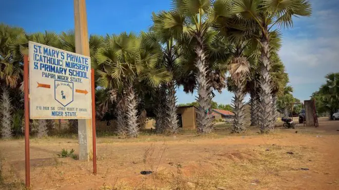 Wide view of entrance to St Mary's Catholic School with di school signboard wey also dey show for di picture
