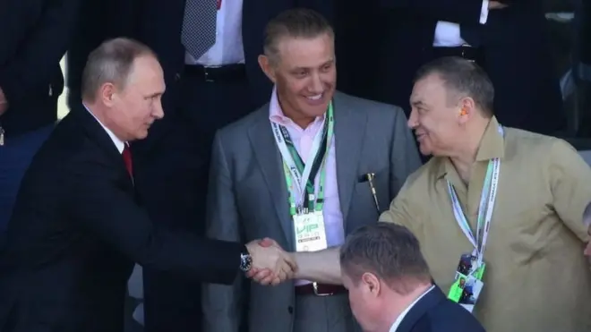 Putin pictured in 2017 shaking hands with Boris and Arkady Rotenberg, dubbed "Putin's cronies" by the UK PM