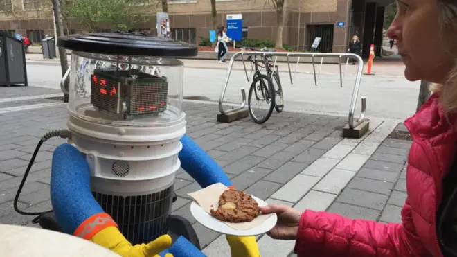 Hitchbot is reborn and sharing a cookie with the BBC's Jane Wakefield