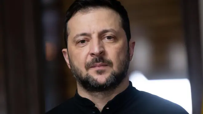 Le président ukrainien Volodymyr Zelensky, l'air sévère, regarde la caméra