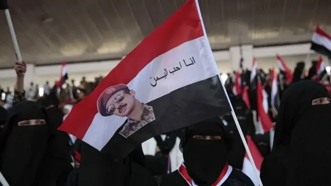 Yemeni woman holds altered national flag during a march in support of a new combined governing council in the rebel-held capital, Sanaa, Yemen 20/08/2016