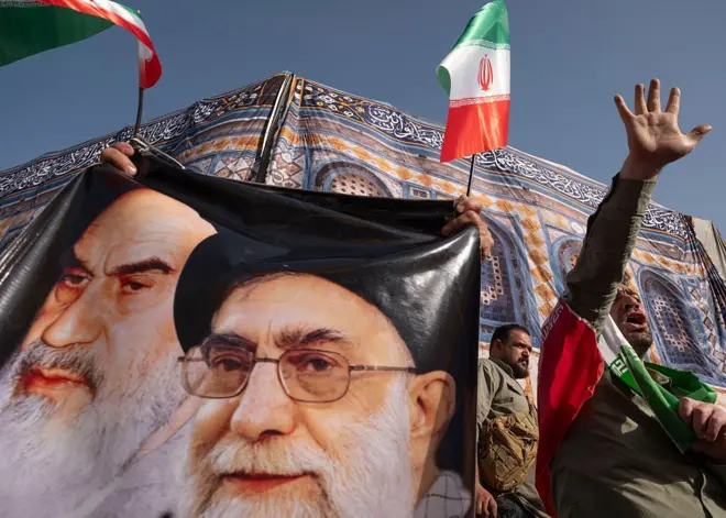 An Iranian protester shouts anti-U.S. and anti-Israeli slogans while standing next to the portraits of Iran's Supreme Leader, Ayatollah Ali Khamenei, and late leader, Ayatollah Ruhollah Khomeini, during a protest to condemn the U.S. attacks on Iran's nuclear facilities in downtown Tehran, Iran, on June 22, 2025, amid the Iran-Israel war. (Photo by Morteza Nikoubazl/NurPhoto via Getty Images)