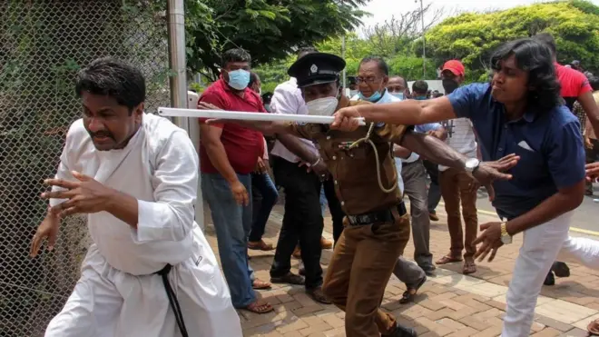Demonstrators and government supporters clash outside the President's office in Colombo on May 9, 2022. - Sri Lanka Prime Minister Mahinda Rajapaksa resigned May 9, his spokesman said, shortly after violent clashes between his supporters and anti-government protesters left 78 people wounded