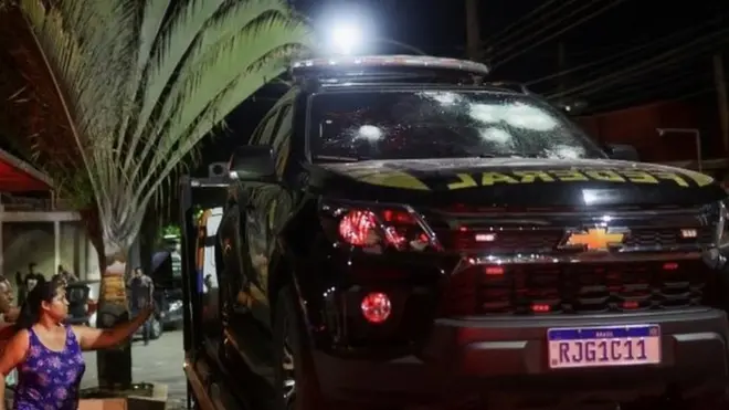 A police car with a shattered windshield was towed away after Sunday's incident