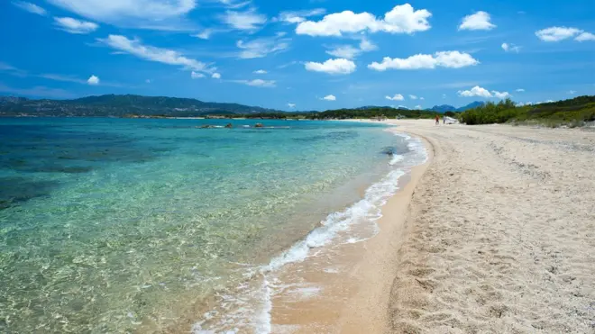 Di white sand of Sardinia beach na treasure for di island - and elsewhere