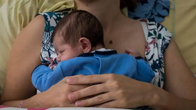 Illustration of an infant baby of only a few days old in his mother's arms after his birth at the Maternity Hospital in Paris, France, on August 23, 2018. Childbirth.
