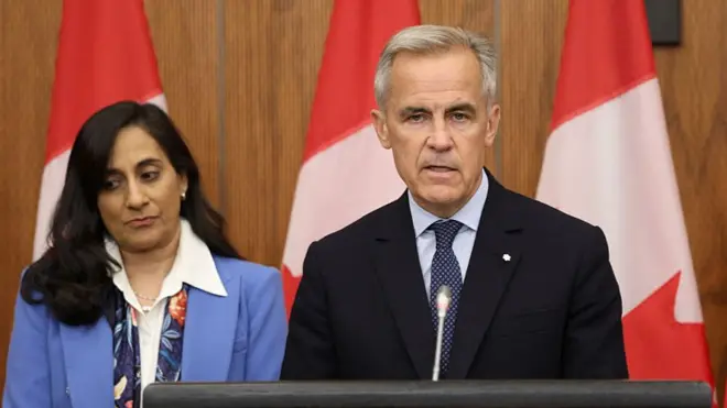 Canadian Foreign Affairs Minister Anita Anand listens to Canadian Prime Minister Mark Carney speak during a press conference in Ottawa on 30 July 2025