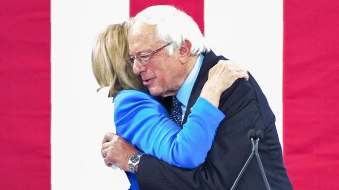 Sanders and Clinton hug