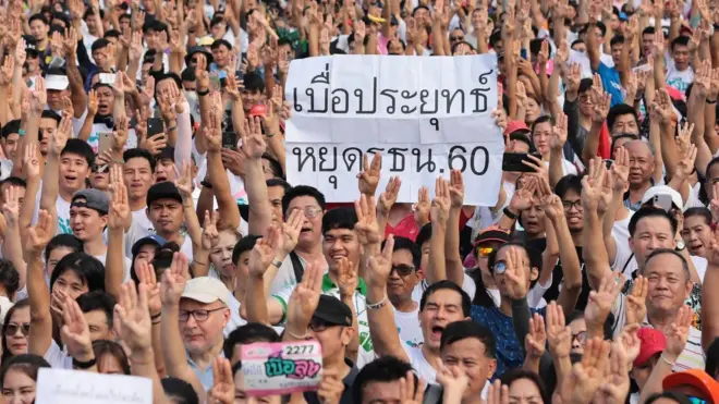 ผู้ร่วมงาน "วิ่งไล่ลุง" เมื่อ 12 ม.ค. แสดงสัญลักษณ์ชู 3 นิ้วไม่เอารัฐธรรมนูญ