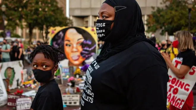 A mother and her son attend a protest in what is now known as Injustice Square Park in the centre of Louisville about the death of Breonna Taylor, who was shot dead by police in September 2020 in Louisville, KY.