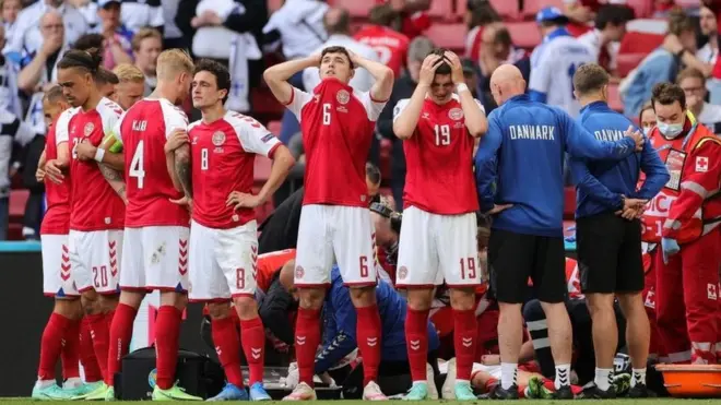 Para pemain Denmark tak kuasa menutupi kesedihan saat mengelilingi Christian Eriksen yang sedang dirawat di lapangan.