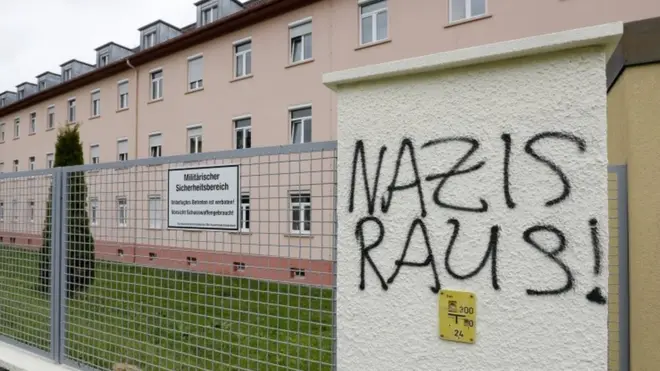 Graffiti reading "Nazis out!" on a fence at the Fuerstenberg barracks in Donaueschingen