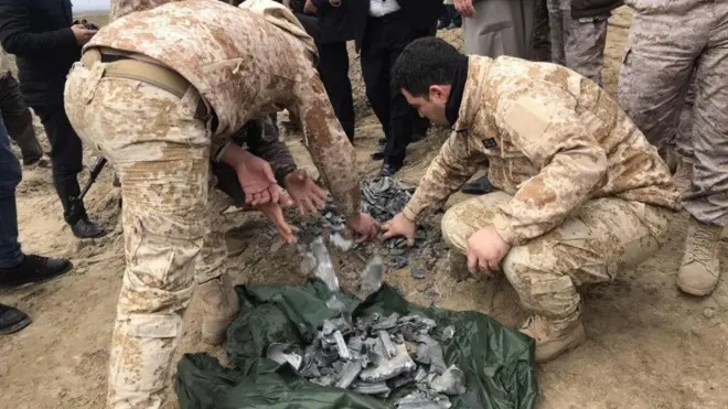 Iraqi security forces gather pieces of Iranian missile in Irbil