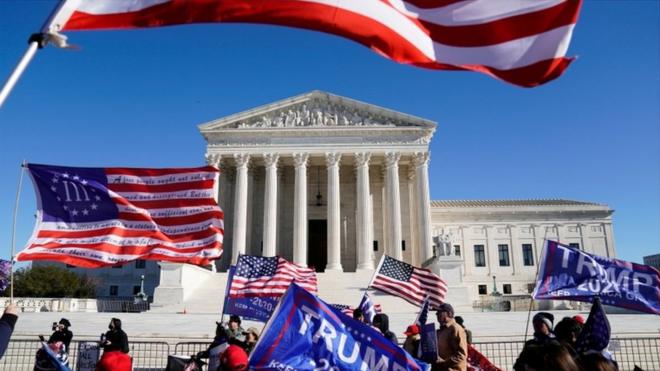 Demonstrators protest outside the Supreme Court on Tuesday