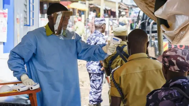 Un médecin vérifie la température de congolais à Mpondwe, dans l'ouest de l'Ouganda, à la frontière de la RDC.